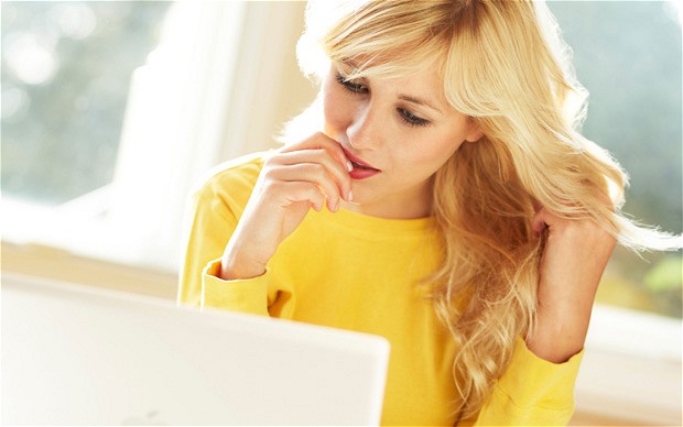 Girl smiling using laptop